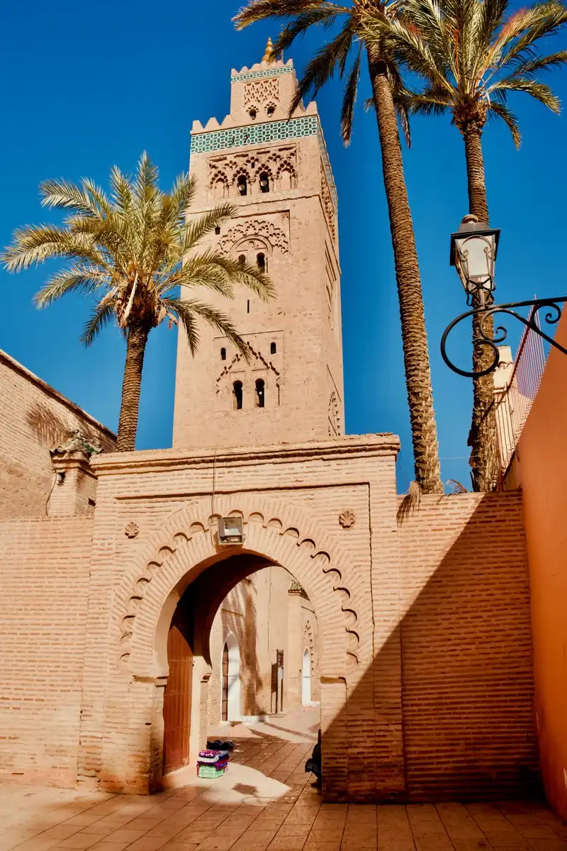 The Koutoubia Mosque minaret in Marrakech framed by palm trees, a focal point during Ramadan evening prayers and Laylat al-Qadr