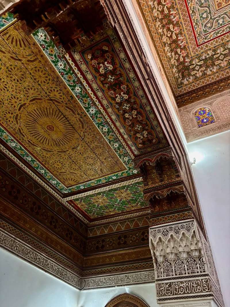 Ornate carved and painted cedar-wood ceiling inside a Marrakech palace.