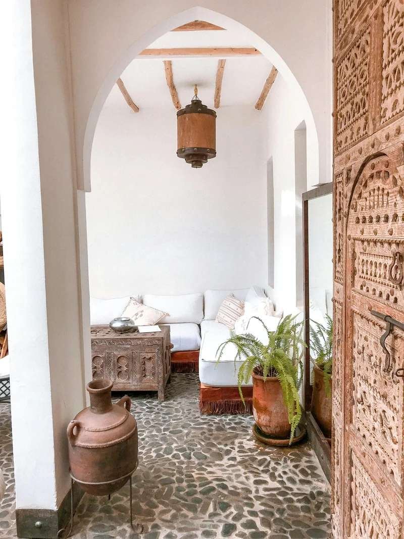 Elegant riad entrance with terracotta walls and traditional Moroccan decor