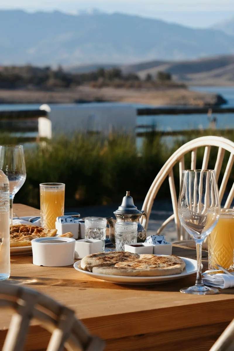 Mountain breakfast spread with panoramic lake and Atlas views