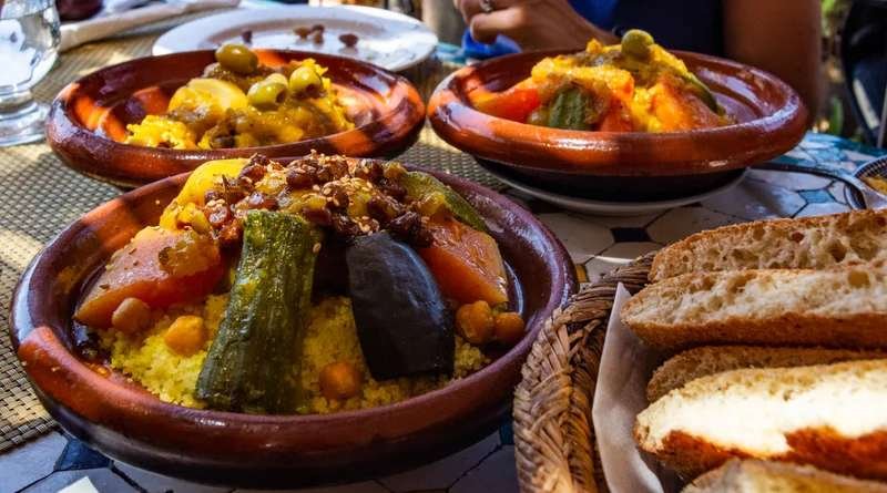 Traditional Moroccan couscous served family-style with vegetables and meat