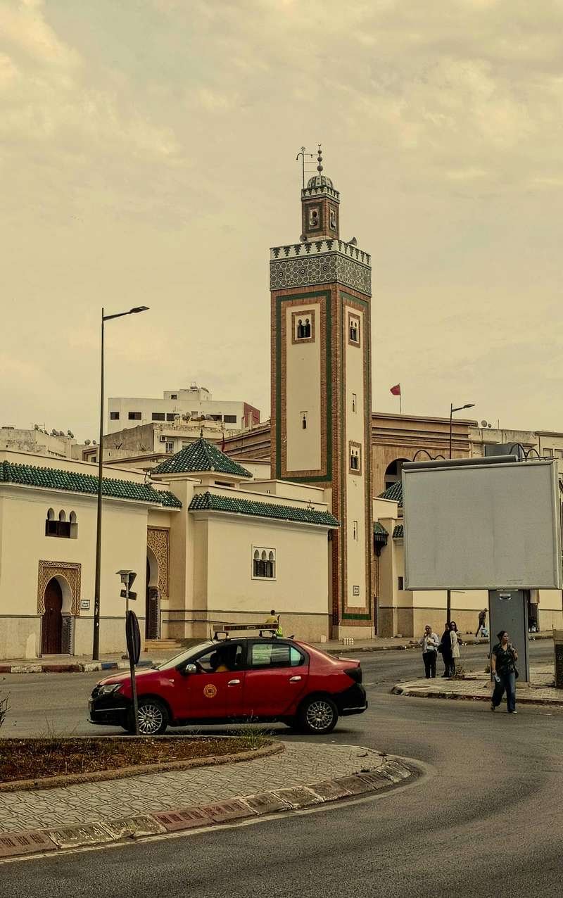 Colorful petit taxi on Moroccan city street demonstrating the accessible urban transportation available in major cities