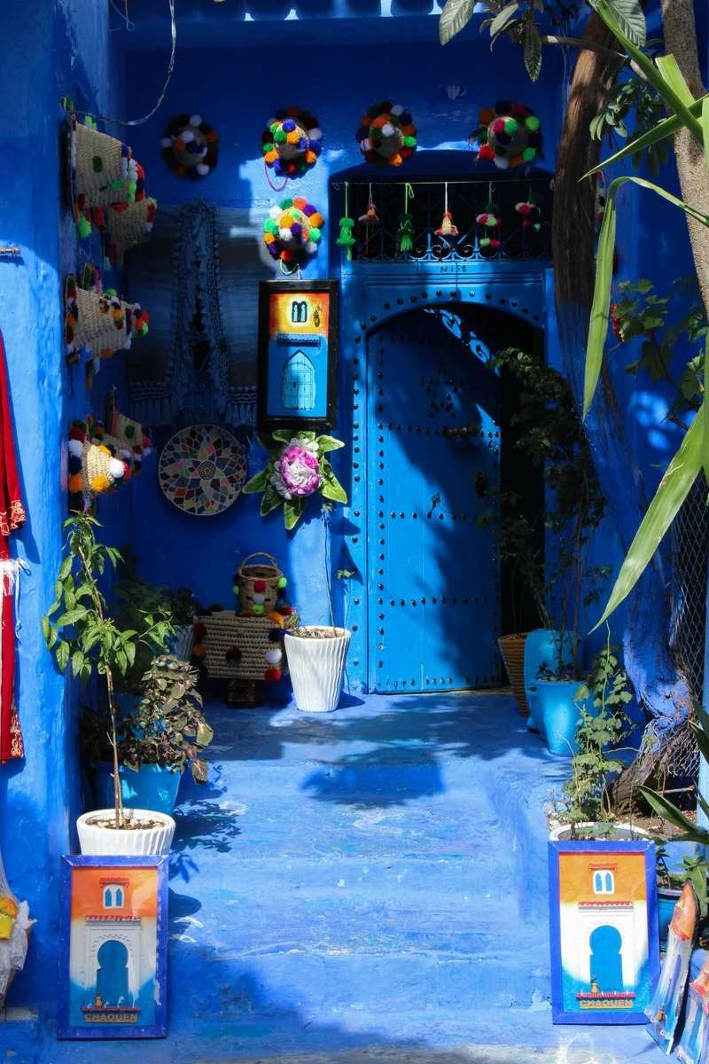 Traditional Moroccan souk displaying woven baskets, textiles and handicrafts in medina marketplace